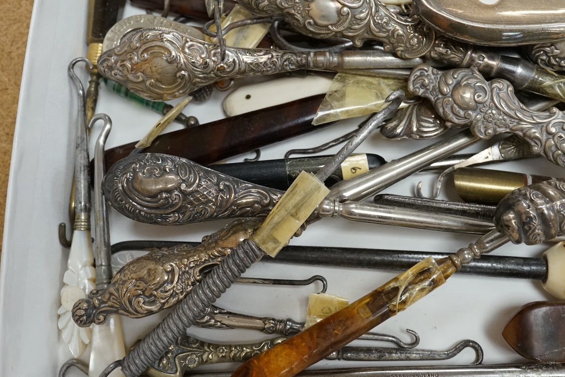 A large collection of Victorian button hooks, with silver, plate, mother of pearl and other handles